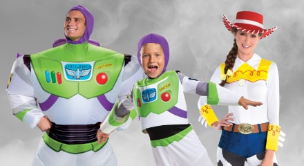 Three people in Toy Story costumes: two dressed as Buzz Lightyear and one as Jessie.