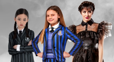 Three people dressed as characters from "Wednesday": two as Wednesday Addams and one as Enid Sinclair.