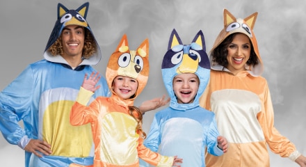 Four people dressed as characters from "Bluey": Bandit, Bingo, Bluey, and Chilli.