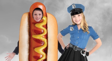 Two children in Halloween costumes: a hot dog and a police officer.