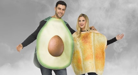 Two adults in Halloween costumes: an avocado and toast.