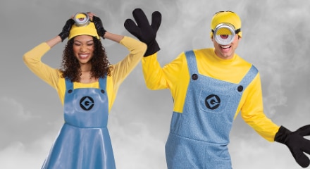 Two people dressed in Minion costumes with yellow shirts, blue overalls, and black gloves.