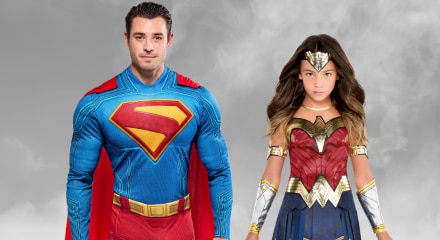 Two people in superhero costumes: Superman and Wonder Woman.