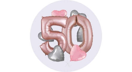 Pink and silver balloons arranged to form the number 50, surrounded by smaller heart-shaped balloons in pink and silver