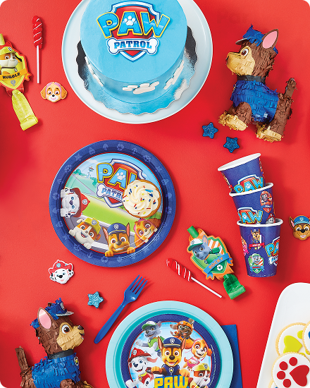 Une table décorée de desserts, de vaisselle, de plats de service et de décorations de fête à thème Pat’ Patrouille.